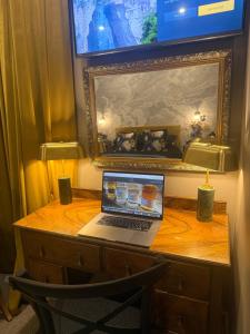 a laptop computer sitting on a wooden desk at MacDonald Arms Hotel in Tobermory