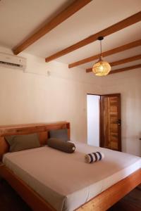 a bedroom with a large bed in a room at Buggei Surfcamp Mentawai in Katiet