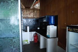 a kitchen with a counter with a coffee maker on it at Buggei Surfcamp Mentawai in Katiet