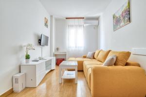 a living room with a couch and a table at Garni Hotel Milica in Herceg-Novi