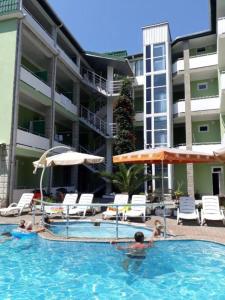a swimming pool in front of a hotel at Green House Hotel N2 in Kobuleti