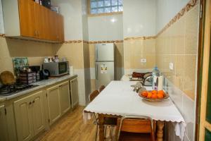 a kitchen with a table with a bowl of oranges on it at Dar El Rezk in Tunis