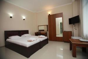 a bedroom with a large bed and a television at Green House Hotel N2 in Kobuleti +22 photos