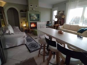 a living room with a table and a couch at To Fournaraki in Gialiskari