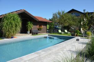a swimming pool in front of a house at Haus Gruber in Attersee am Attersee