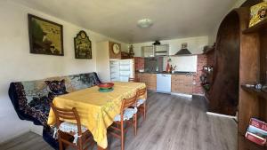 a kitchen with a table with a dog sitting at it at The Luff & Match B&B in IDRO +10 photos