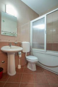 a bathroom with a toilet and a sink and a tub at Pansion 22 CETINJE in Cetinje +7 photos