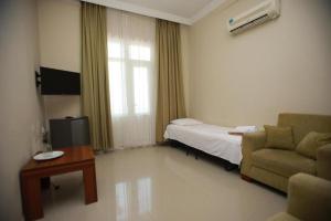 a room with a bed and a couch and a table at Green House Hotel N2 in Kobuleti