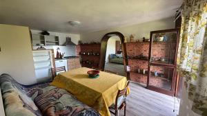 a living room with a table and a kitchen at The Luff & Match B&B in IDRO