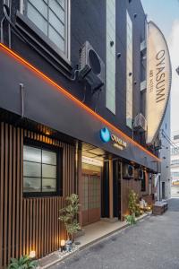 a building with a sign on the side of it at OYASUMI Art HOTEL Dotonbori 24-Hour Check-in Pressure-relief mattress in Osaka