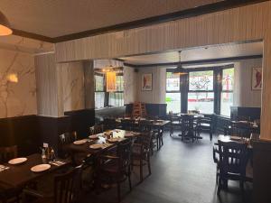 a dining room with tables and chairs in a restaurant at Rowton Poplars Hotel in Chester
