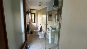 a bathroom with two toilets and a sink and a shower at The Luff & Match B&B in IDRO