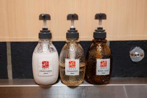 three bottles of soy sauce sitting on a kitchen counter at OYASUMI Art HOTEL Dotonbori 24-Hour Check-in Pressure-relief mattress in Osaka