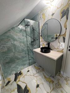 a bathroom with a mirror on a wall at Casa din Frasin in Poiana Mărului +39 photos