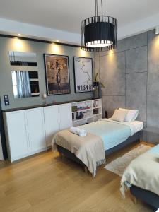 a bedroom with two beds and a mirror at Visit Poznan in Dąbrówka