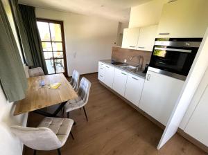 a kitchen with a table and a sink and a stove at Haus Gruber in Attersee am Attersee