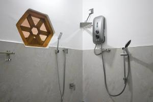 a bathroom with a shower and a shower head at Ceylon Luminara in Veyangoda