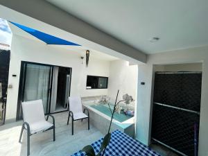 a living room with a table and two chairs at Apartamento completo punta cana in Punta Cana