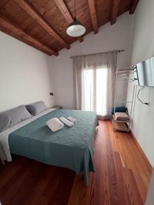 a bedroom with a bed with two towels on it at RossoScirì in Calatafimi +22 photos