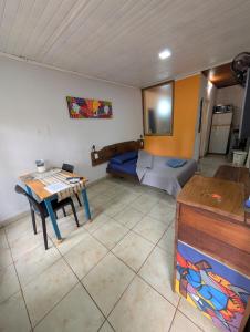 a living room with a table and a couch at Aloha hospedaje in Puerto Iguazú