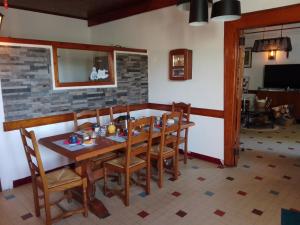 a dining room with a wooden table and chairs at LA MAISON DE BARLEST - LOURDES in Barlest