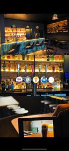 a bar in a restaurant with a counter top at MacDonald Arms Hotel in Tobermory