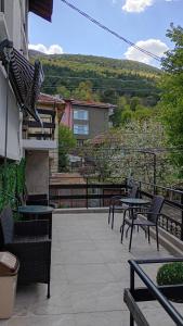 a patio with tables and chairs on a balcony at ВЛАД ДОМ Студио in Vratsa