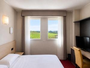 a hotel room with a bed and a window at Hotel Ristorante al Giardinetto in Colle Umberto +51 photos