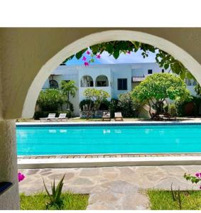 a swimming pool with an arch over it at Summer Studio Suit in Malindi