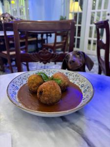a plate of food sitting on a table with a dog at Casa Pichay Family Room in Vigan
