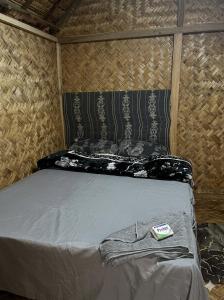 a bed in a small room with at Asaro Mudman Cultural Lodge in Goroka +10 photos