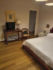 a bedroom with a bed and a desk with a television at Casa Daniela in Velletri