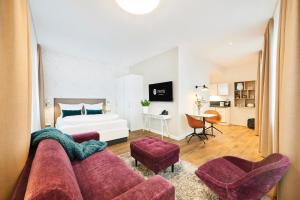 a living room with a couch and a bed at Nena Apartments Bremen by LESA in Bremen