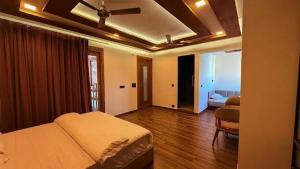 a bedroom with a bed and a chair in a room at Yes Hotel By The Ganges Rishikesh in Rishīkesh +12 photos