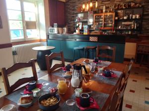 a table with breakfast food on it in a restaurant at LA MAISON DE BARLEST - LOURDES in Barlest