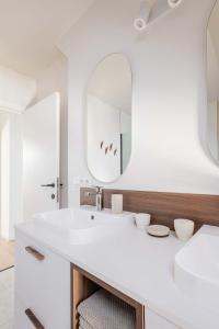 a white bathroom with a sink and a mirror at Vakantiewoning Gast in Borgloon +26 photos