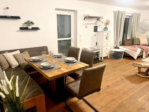a living room with a table and a couch at Gemütliche Ferienwohnung Casa Caliora, 8km zum Biggesee in Drolshagen +22 photos