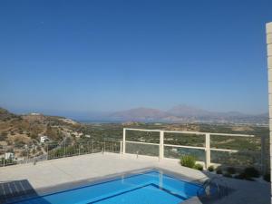 a swimming pool with a view of the mountains at Villa Ovgoro - Luxury 3-Level Villa with Heated Pool, Jacuzzi and Panoramic Views in Kamilari