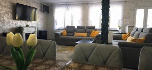 a living room with couches and yellow pillows at Belvedere Panaci in Coverca