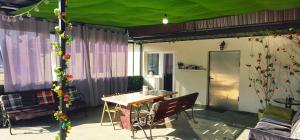 a patio with a table and a green tent at Belvedere Panaci in Coverca