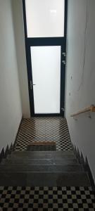 a white door with a checkered floor in a room at Vilem in Komárov