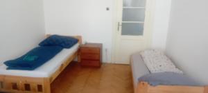 a small bedroom with two beds and a table at Vilem in Komárov