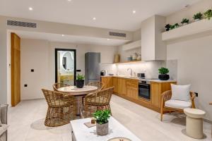 a kitchen with a table and chairs and a counter at Pnoe Villas Syros in Megas Gialos - Nites +73 photos