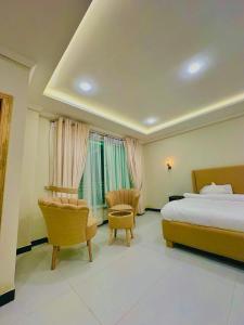 a hotel room with a bed and a chair at Pine Peaks Heaven in Nathia Gali