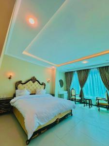 a large bedroom with a large bed and blue lighting at Pine Peaks Heaven in Nathia Gali