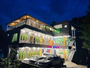 a building with cars parked in front of it at Pine Peaks Heaven in Nathia Gali