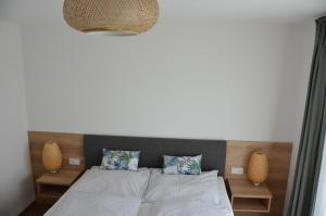 a bedroom with a bed and two vases on the wall at Haus Gruber in Attersee am Attersee +50 photos