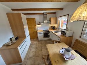 a small kitchen with a table and a counter top at Wieshof Schnals Bauernhofurlaub in Maso Corto +9 photos