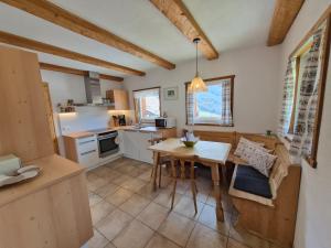 a kitchen with a table and a dining room at Wieshof Schnals Bauernhofurlaub in Maso Corto
