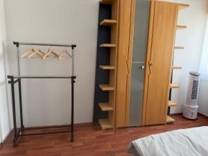 a bedroom with a closet with hangers and a door at Burato`s Haus in Minden